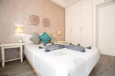 a bedroom with a white bed with pillows on it at Appartamento 14 a Guelize Hivernage in Marrakech