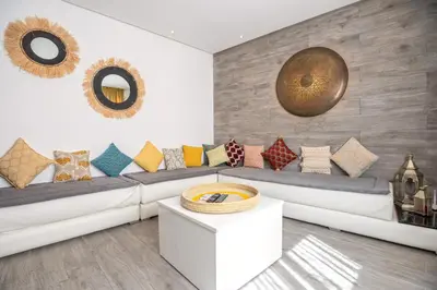 a living room with a couch with pillows on it at Appartamento 14 a Guelize Hivernage in Marrakech