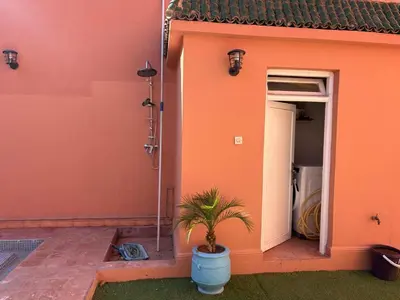 a plant in a blue pot in front of a building at Villa Lyazidi in Marrakech