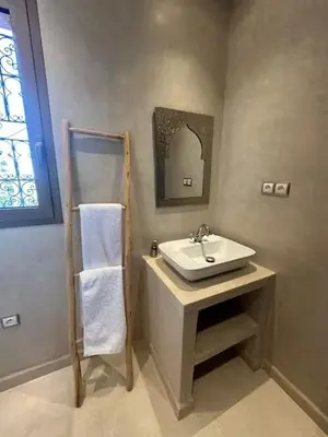 a bathroom with a sink and a mirror at Villa Dar AL Manel in Aït Amara