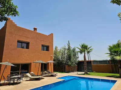 a house with a swimming pool next to a building at Villa Dar AL Manel in Aït Amara