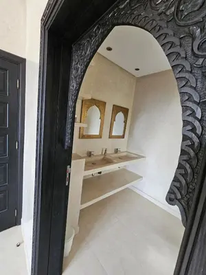 a bathroom with two sinks and a mirror at Villa Dar AL Manel in Aït Amara