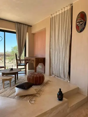 a living room with a large pillow on the floor at Villa Kela Serene in Marrakech
