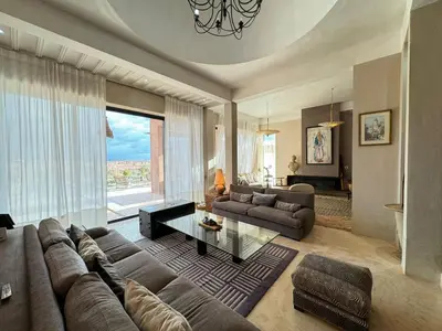 a large living room with a couch and a table at Villa Kela Serene in Marrakech