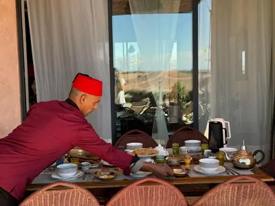 a man sitting at a table eating food at Villa Kela Serene in Marrakech