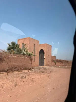 a building in the middle of a dirt road at Villa Kela Serene in Marrakech