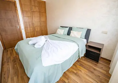 a bedroom with a large bed with towels on it at Appart Mayar 52 in Marrakech