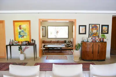 a living room with white chairs and a couch at Villa Tulum - Indoor Spa & Pools in Marrakech