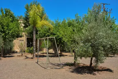 a swing set in the middle of a yard with trees at Villa Tulum - Indoor Spa & Pools in Marrakech