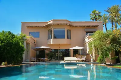 a house with a swimming pool in front of a house at Villa Tulum - Indoor Spa & Pools in Marrakech