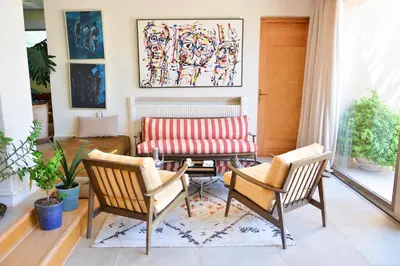 a living room with two chairs and a couch at Villa Tulum - Indoor Spa & Pools in Marrakech