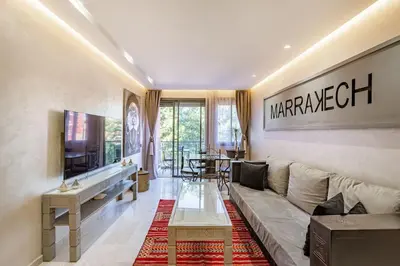 a living room with a couch and a television at New ! Bright And Comfortable App in city center in Marrakech