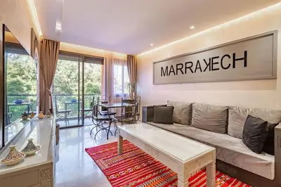 a living room with a couch and a table at New ! Bright And Comfortable App in city center in Marrakech