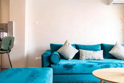 a blue couch with pillows in a living room at Appartement Miramas 2 Gueliz pool,Gym in Marrakech