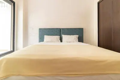 a bedroom with a large bed with a blue headboard at Appartement Miramas 2 Gueliz pool,Gym in Marrakech