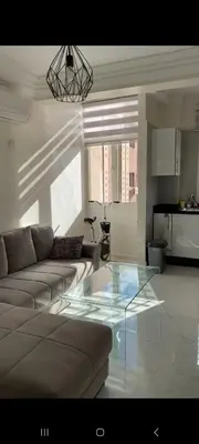 a living room with a couch and a glass table at appartement de luxe a Marrakech in Marrakech