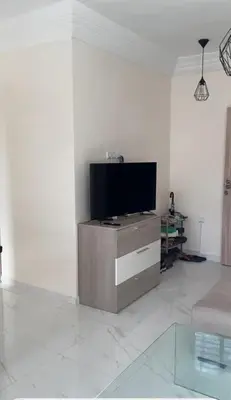 a living room with a flat screen tv on a cabinet at appartement de luxe a Marrakech in Marrakech