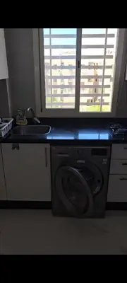 a washing machine in a kitchen with a window at appartement de luxe a Marrakech in Marrakech