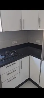 a kitchen with white cabinets and a stove top oven at appartement de luxe a Marrakech in Marrakech