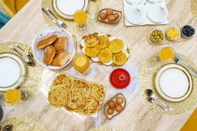 a table with eggs and bread and plates of food at Villa Riad Sultana in Marrakech