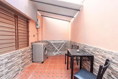 a small room with a table and a small refrigerator at Cozy appartement à Gueliz juste les familles in Marrakech