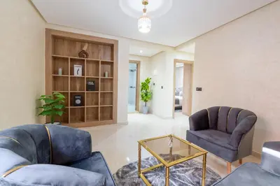 a living room with two chairs and a table at Cozy appartement à Gueliz juste les familles in Marrakech