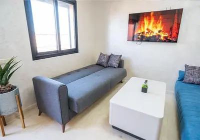 a living room with a couch and a fire place at Appart Mayar 58 in Marrakech