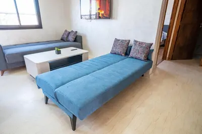 a living room with a couch and a table at Appart Mayar 58 in Marrakech