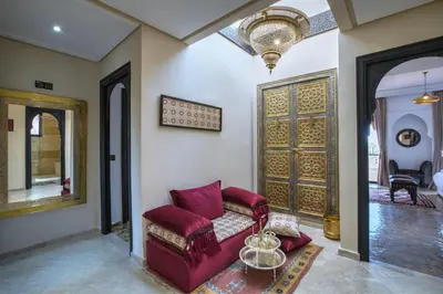 a living room with a red couch and a door at Villa Akadia luxurious with private swimming pool in Marrakech