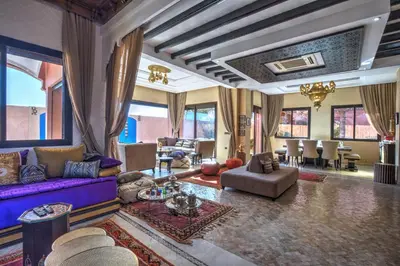 a living room with a purple couch and chairs at Villa Akadia luxurious with private swimming pool in Marrakech