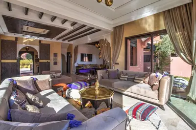 a living room with couches and a table at Villa Akadia luxurious with private swimming pool in Marrakech