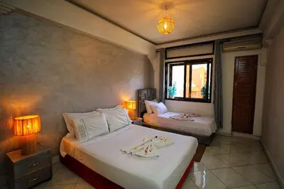 a bedroom with two beds and a window at La Nina Appartement Marrakech in Marrakech