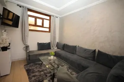 a living room with a couch and a table at La Nina Appartement Marrakech in Marrakech