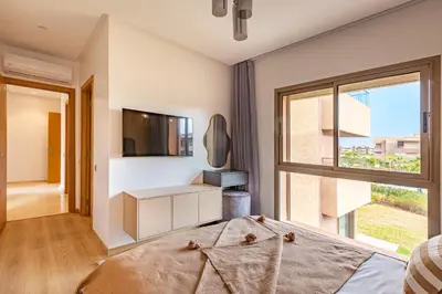 a bedroom with a bed and a window at New! Résidence de Luxe avec Piscine & parking in Marrakech