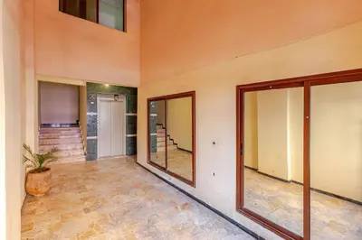 an empty room with glass doors and a potted plant at Séjour Authentique à Marrakech Confort et Charme in Marrakech