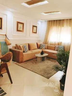 a living room with a couch and a table at Family House Marrakech in Marrakech