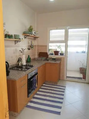 a kitchen with a stove and a counter top at Family House Marrakech in Marrakech
