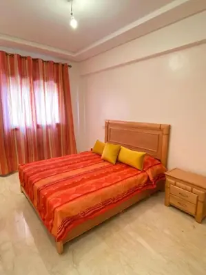 a bedroom with a bed with two yellow pillows at Condo in Marrakech in Marrakech
