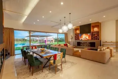 a dining room and living room with a table and chairs at Villa des stars in Marrakech