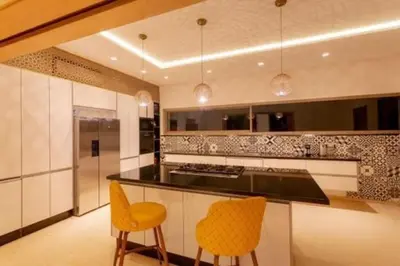 a kitchen with two yellow chairs and a counter at Villa des stars in Marrakech