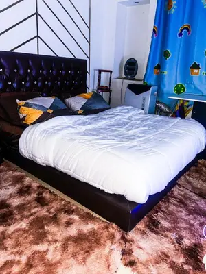 a large bed in a room with a bed sqor at Your Home Away From Home in Marrakech