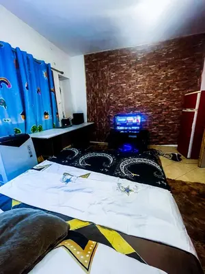 a bedroom with a bed with a gaming system on it at Your Home Away From Home in Marrakech
