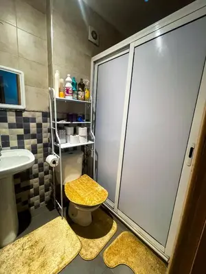 a bathroom with a shower with a toilet and a sink at Your Home Away From Home in Marrakech