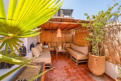 a patio with couches and potted plants at Dar Karole-Privé-petits déjeuners inclus in Marrakech