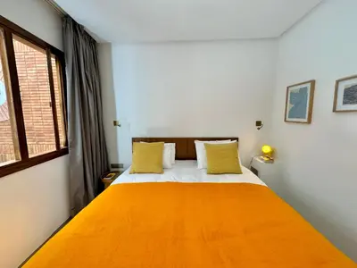 a bedroom with a large bed with yellow pillows at Riad Ziya - Private very close to Jamaa El Fna in Marrakech