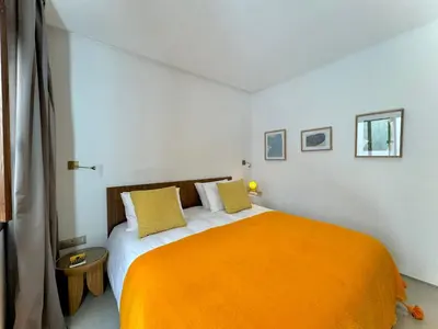a bedroom with a bed with an orange blanket at Riad Ziya - Private very close to Jamaa El Fna in Marrakech