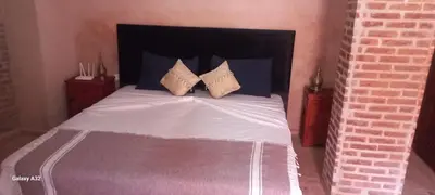a bed with two pillows on it in a bedroom at Riad maison Bounouar in Marrakech