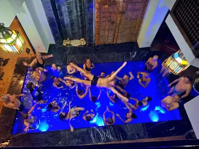 a group of people in the water at a swimming pool at Riad maison Bounouar in Marrakech