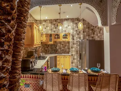 a kitchen with yellow cabinets and a refrigerator at Riad Le Nid De Fatima in Marrakech
