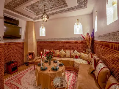 a living room with a couch and a table at Riad Le Nid De Fatima in Marrakech